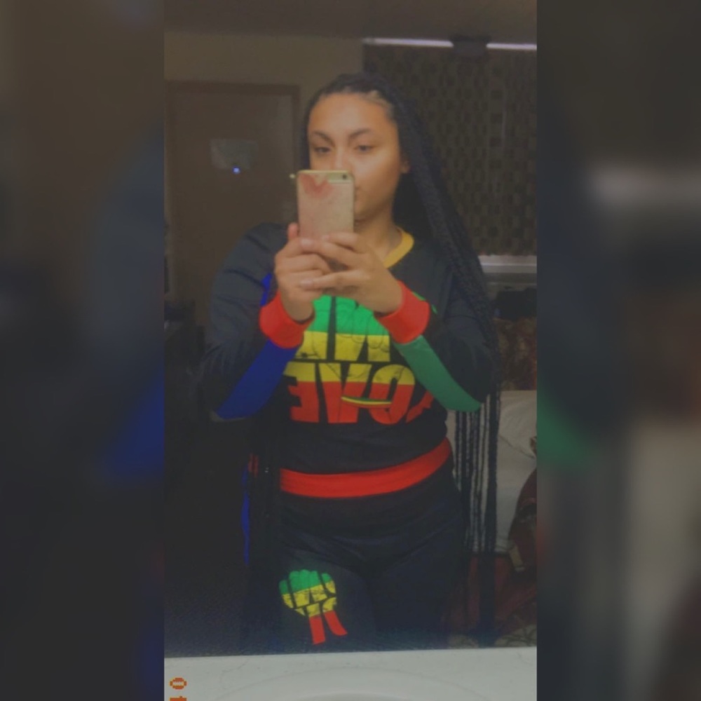 Size large. One love red, green, yellow, blue and black long sleeve outfit